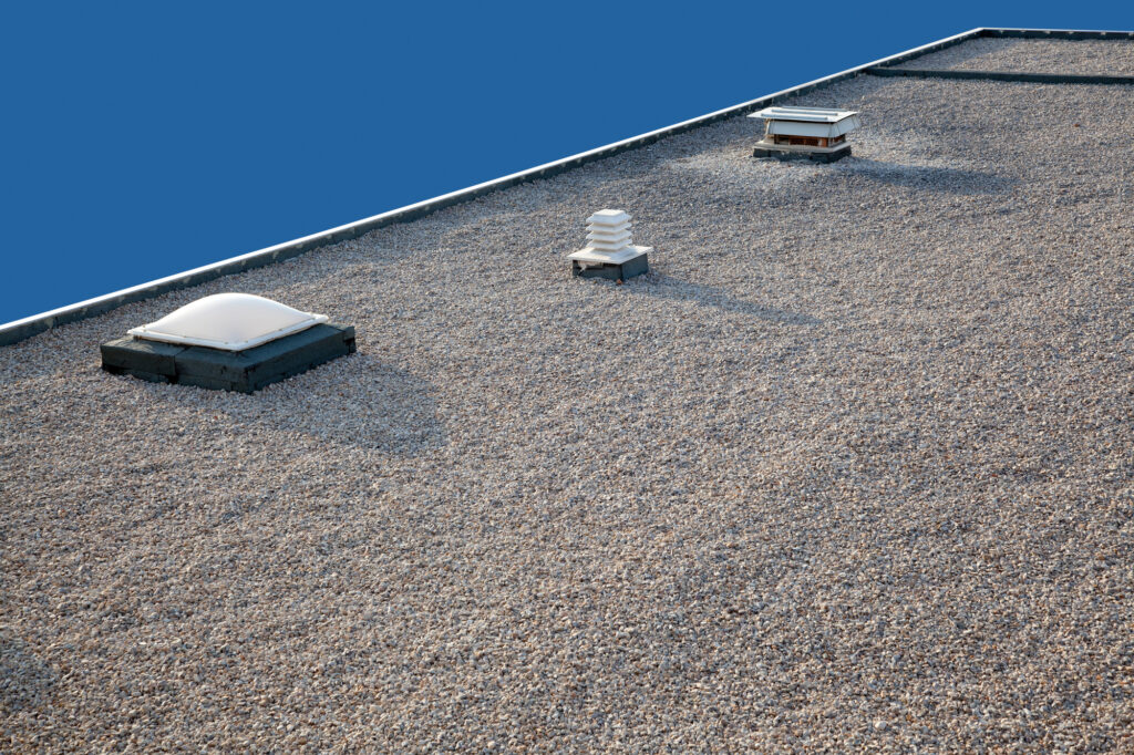 Flat roof with gravel and chimney